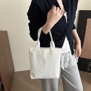 Minimalist white corduroy tote bag with FANYISSA brand label for casual daily use