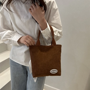 Brown corduroy shoulder bag with vertical stripe texture for casual daily commute wear