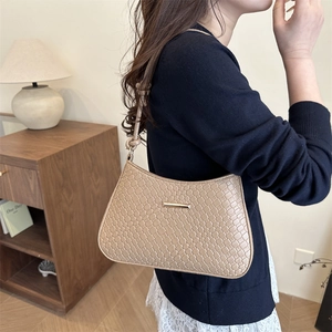 Minimalist beige woven texture baguette shoulder bag with knotted strap and gold hardware