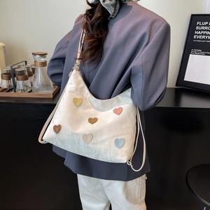 White heart-patterned tote bag for women with wide shoulder straps in a minimalist style