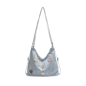 Light blue nylon tote bag with colorful heart patches and adjustable shoulder strap