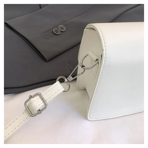 Close-up of white PU leather bag with silver metal hook and fine stitching detail