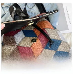 Detail display of the strong magnetic closure on a colorful patchwork crossbody bag