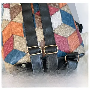 Detail display of adjustable golden buckles and multi-color patchwork leather on the backpack