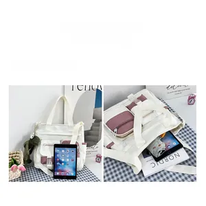 Detail view of white canvas tote bag featuring multi-pocket layout and storage capacity