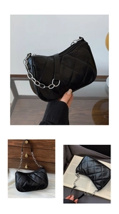 Detail of black quilted shoulder bag with silver chain and artificial leather texture