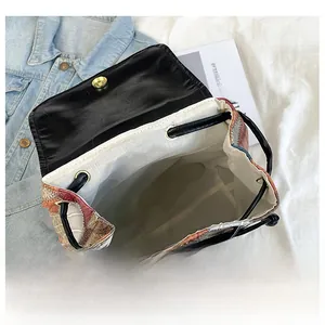 Detail display of a large patchwork backpack interior with magnetic flap and drawstring closure