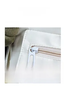 Detail view of smooth metal zipper and durable nylon fabric on a casual shoulder bag