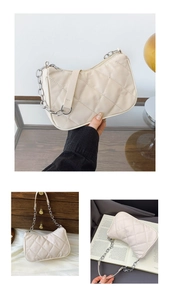 Detail of quilted texture and silver chain strap on creamy white faux leather shoulder bag