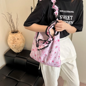 Chic floral tote bag with pink patterns and black ruffled edges for casual daily use