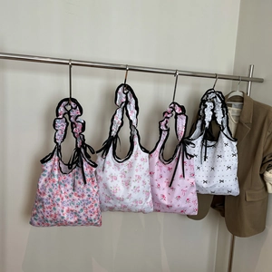 Floral canvas tote bags with ruffled straps and ribbon details in four stylish patterns