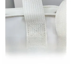 Close-up of reinforced cross-stitching on the canvas tote bag handles for durability