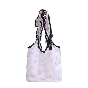 Floral print canvas tote bag with black ruffle straps and bow decoration