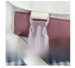 Detail of a minimalist college-style tote bag with a white plastic buckle closure