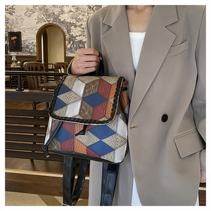 Detail of retro patchwork handbag with embossed textures and contrast stitching