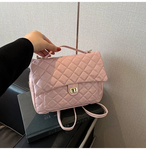 Detail of pink quilted tote bag with gold rectangular turn-lock and soft PU leather texture