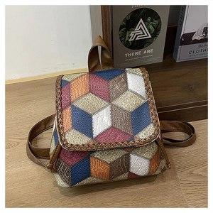 Detail of colorful geometric patchwork PU leather backpack with braided edge and pebble texture