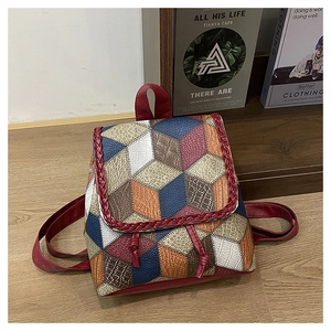 Top view of patchwork leather backpack with geometric color blocks and woven trim detail