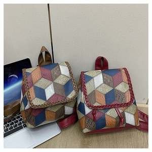 Detail of color-block geometric pattern backpack with woven edges and textured synthetic leather