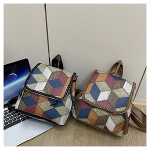 Detail of multi-color geometric PU leather crossbody bag with lychee texture and weaving
