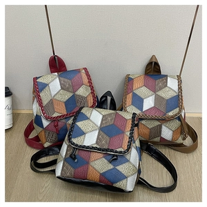 Detail of multi-color geometric 3D pattern and textured PU leather on crossbody bags
