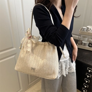 Minimalist beige woven tote bag with silver bow accent and floral lace ribbon detail