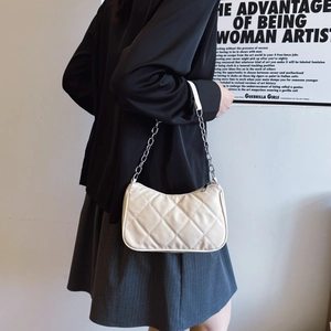 Chic beige quilted shoulder bag with silver chain strap for a trendy minimalist look