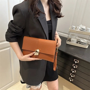 Fashionable brown envelope clutch with horizontal embossing and geometric gold buckle