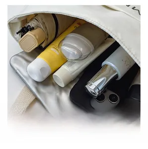 Macro view showing the large internal capacity of the white canvas tote bag for daily use