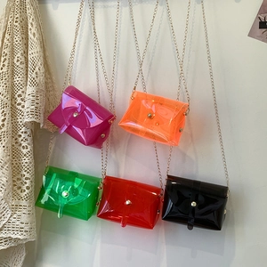 Five assorted colorful transparent PVC jelly crossbody bags with gold chain straps