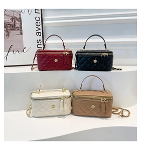 Detailed view of quilted box bags with camellia hardware and chain straps in four colors