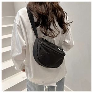 Vue détaillée du sac demi-lune en nylon noir avec bandoulière réglable et logo