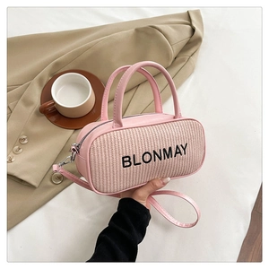 Detail of pink and beige woven crossbody bag with BLONMAY logo and leather handle