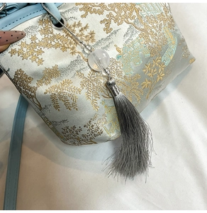 Detail of light blue brocade embroidery and tassel on the Chinese style bucket bag