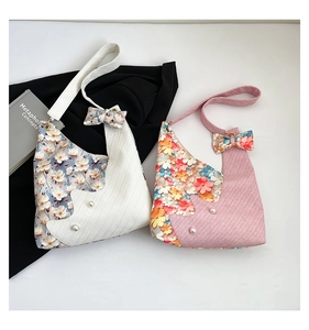 Floral patchwork tote bags with pearl accents and bow straps on a minimalist background