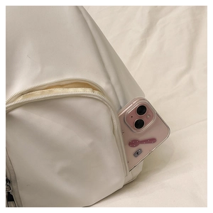Detail of white backpack side hidden zipper pocket with pink smartphone for capacity scale