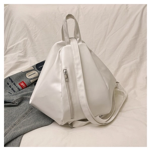 Macro shot of white geometric triangle pattern and vertical zipper on the leather backpack