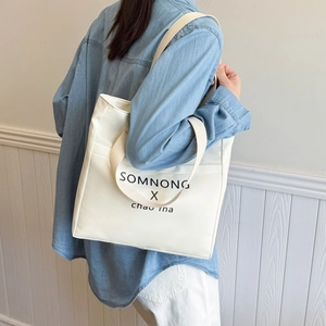 Minimalist cream canvas tote bag with black lettering print for daily campus commuting