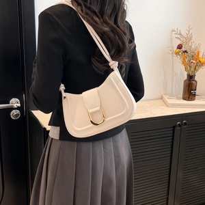 Minimalist beige half-moon underarm bag with gold horseshoe buckle and knotted strap