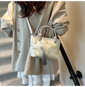 Detail of Chinese style bucket bag with flower and bird embroidery and tassel