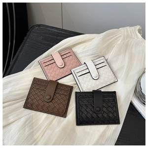 Detailed view of woven texture card holders in pink, white, brown, and black sets