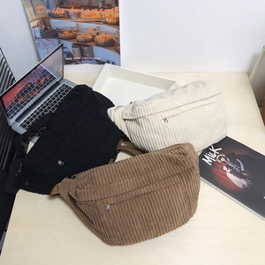 Three corduroy waist bags in black, white, and brown with adjustable straps and retro design