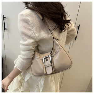 Detail of a khaki crescent shoulder bag featuring a silver buckle and adjustable strap