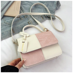 Close-up of pink and white textured leather patchwork handbag with a fashion tag detail