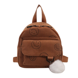 Brown corduroy mini backpack for kids featuring a smiley face and plush ball charm