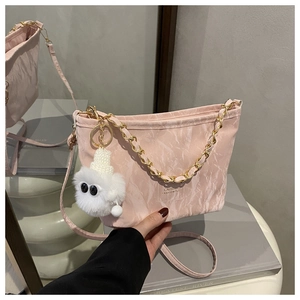 Pink marble tote with gold chain strap and cute white plush monster pendant