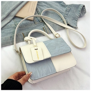 Detail of color-block PU leather bag with marble texture and fashion logo tag
