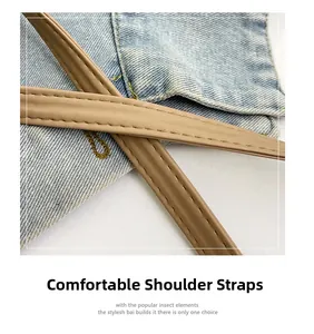 Detail of comfortable faux leather straps and light blue denim fabric on summer bucket bag