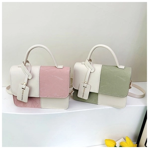 Detail of trendy color-block leather handbags with fine textures and fashion tags