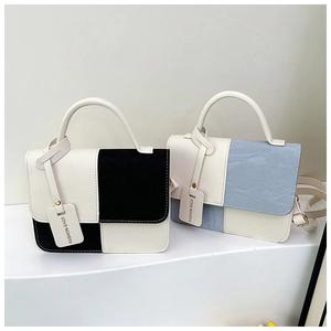 Close-up of contrast color mini square bags with flap closure and fashion tags